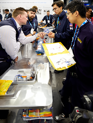 An exhibitor showing his product to an attendee